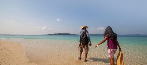 Couple enjoy a romantic moment at the scenic Jolly Buoy island, Andaman, India.
